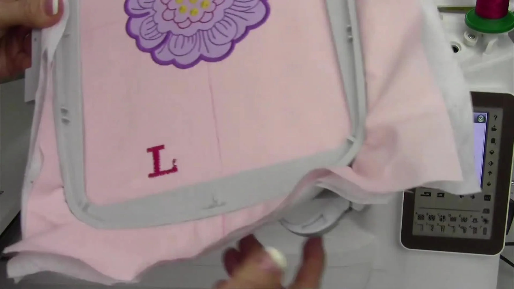 An extreme close-up of a stitched letter “L” shows jagged satin edges where white bobbin thread has been pulled to the top.