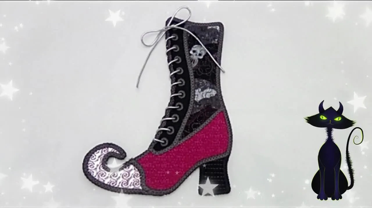 A finished 3D in-the-hoop Witch’s Boot standing upright, showing the bat-print shaft and threaded elastic laces.