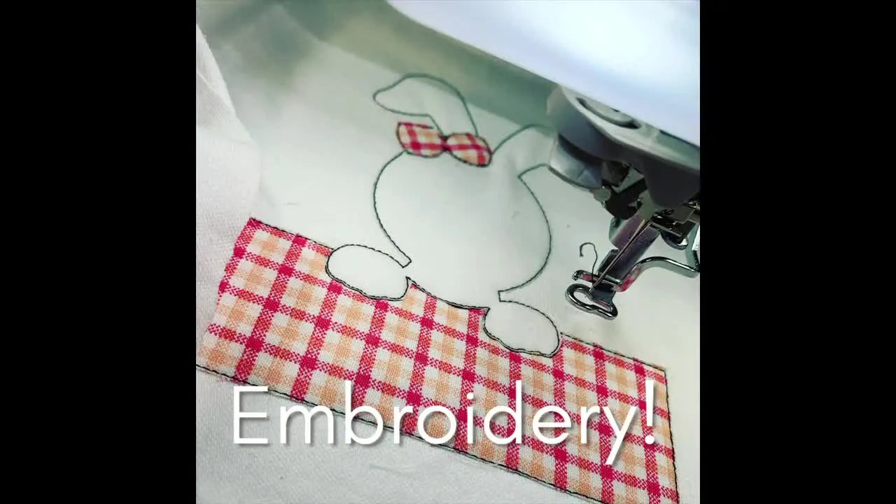 Close up of an embroidery machine stitching a bunny design on a plaid fabric.