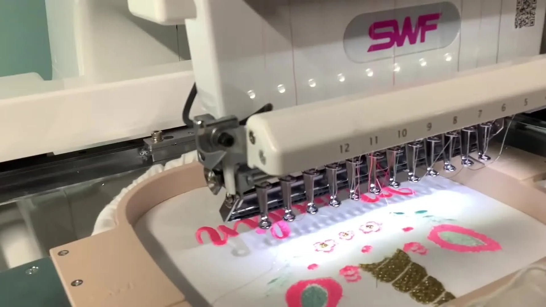 A close-up of the SWF MAS-12 stitching a metallic gold unicorn horn smoothly after correcting the needle orientation.