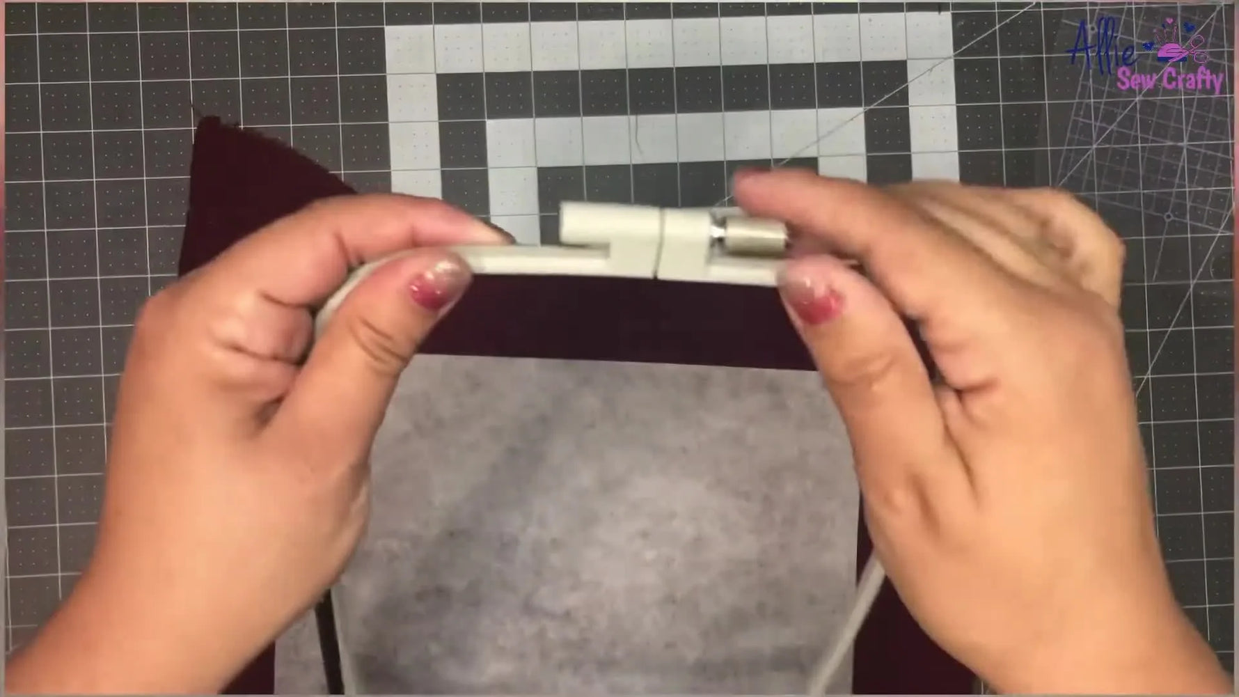 The Brother SE1900 is stitching a floral heart cleanly in the hoop with the start button lit green after the correct spool insert and hooping setup are used.