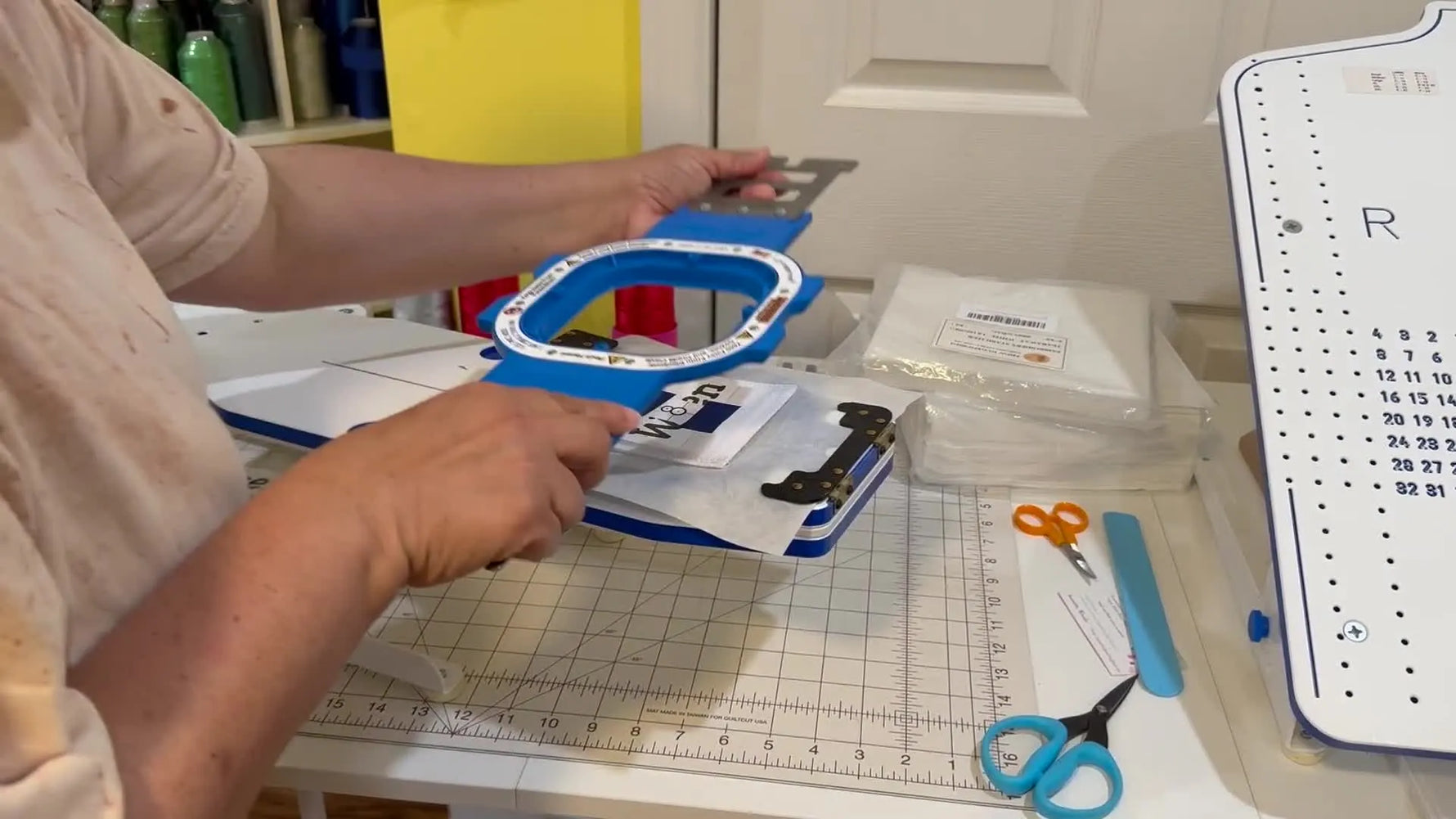 A close-up of the 4.25-inch magnetic hoop snapping onto the bottom ring to secure a small Velcro patch instantly.