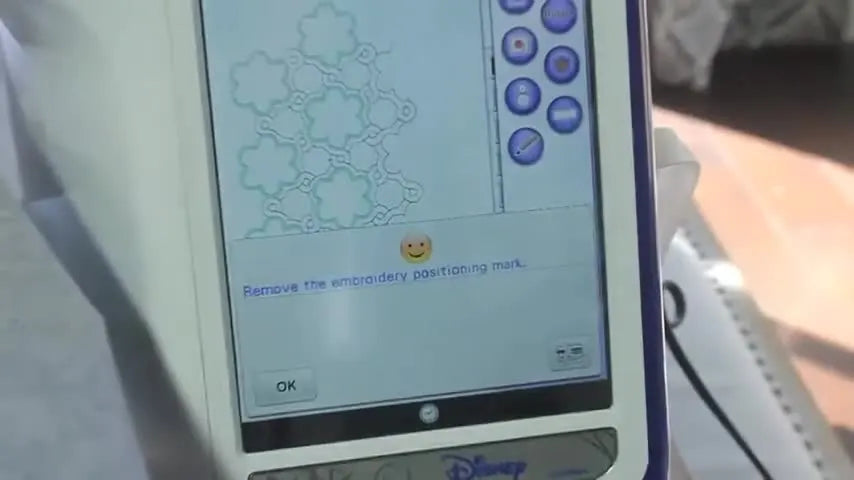 A close-up of the Dream Machine screen showing the smiley face confirmation that the Snowman sticker has been recognized for perfect camera alignment.