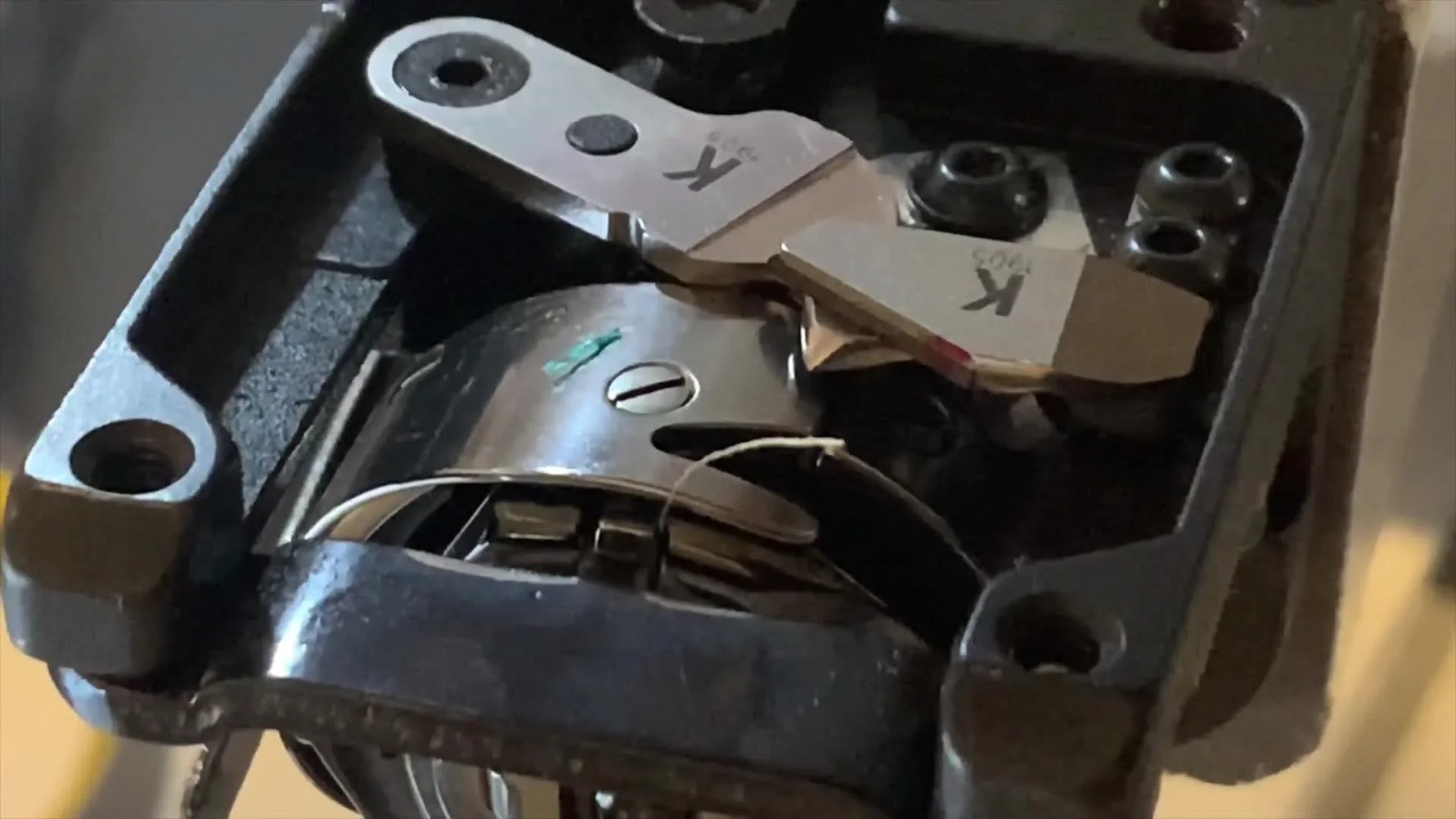 A top-down view of the exposed Redline trimmer mechanism with the movable and fixed knives clearly identified.