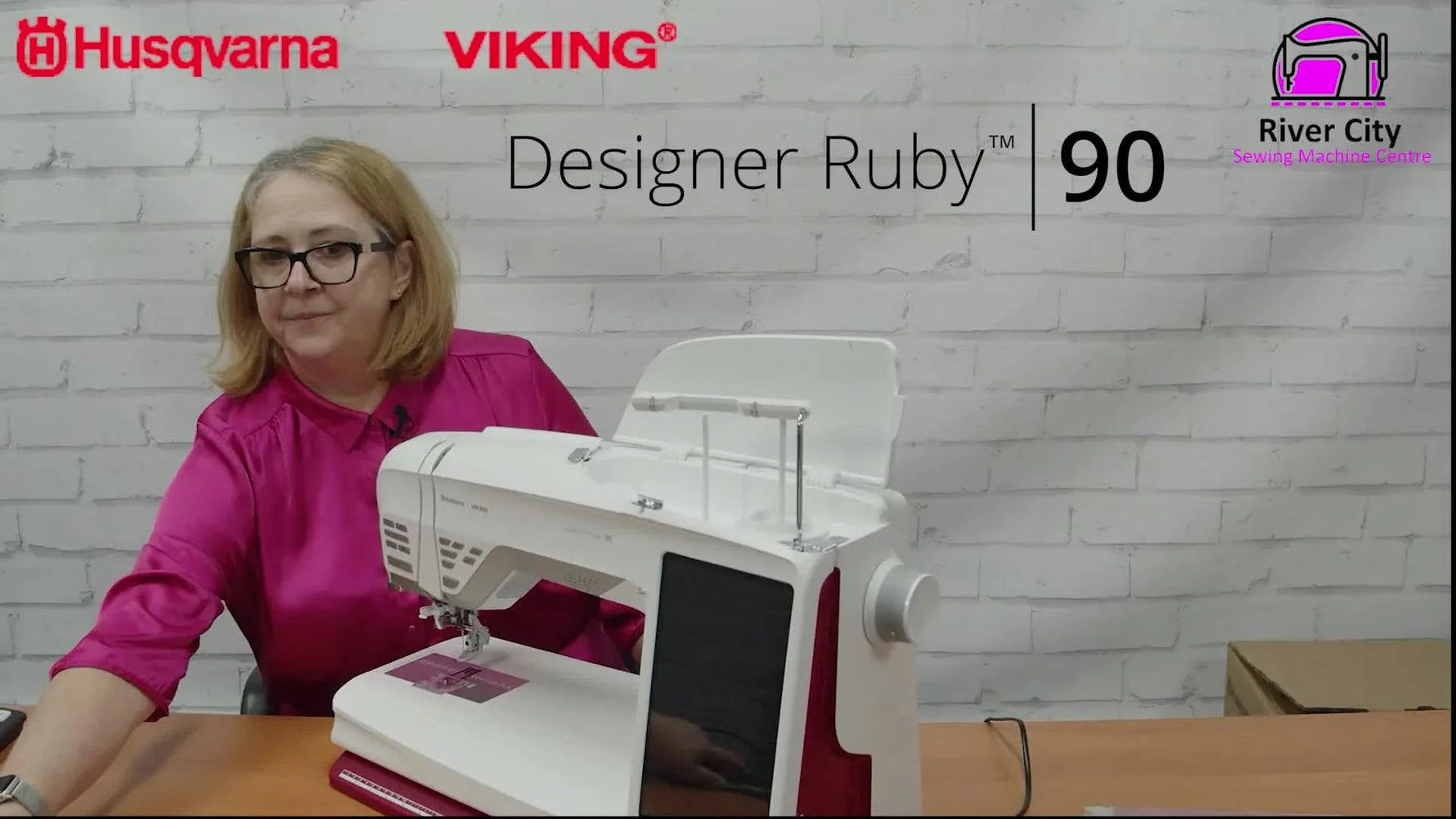 A new Husqvarna Viking Designer Ruby 90 owner stands beside the machine, ready to unbox and set up the embroidery system.