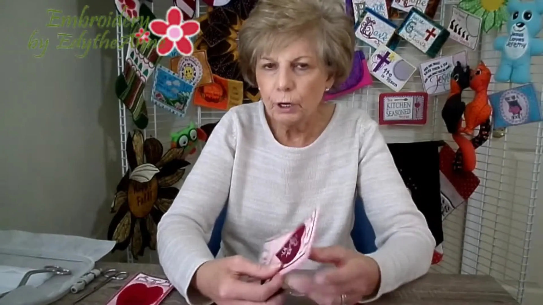 The presenter holds a finished fringed bookmark so you can clearly see the design and the fringe effect.