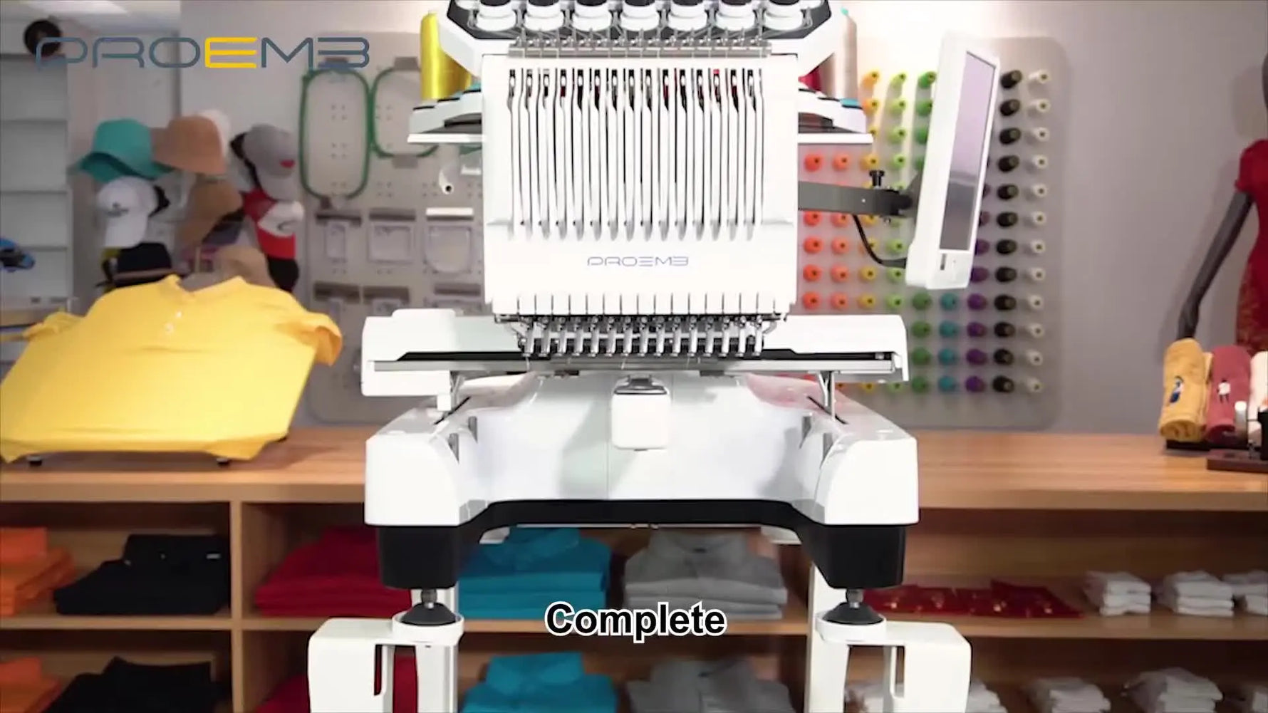 A fully assembled PROEMB multi-needle embroidery machine sits securely on its completed metal stand with the wire rack installed behind it.