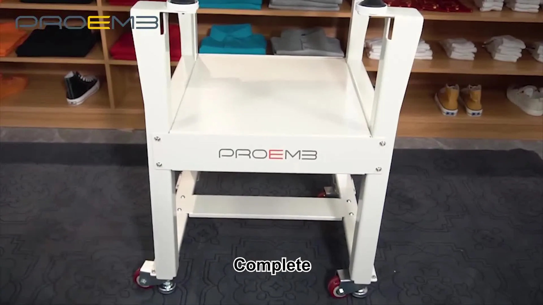 A fully assembled PROEMB embroidery machine sits level on its metal stand with the thread wire rack installed and ready for cones.