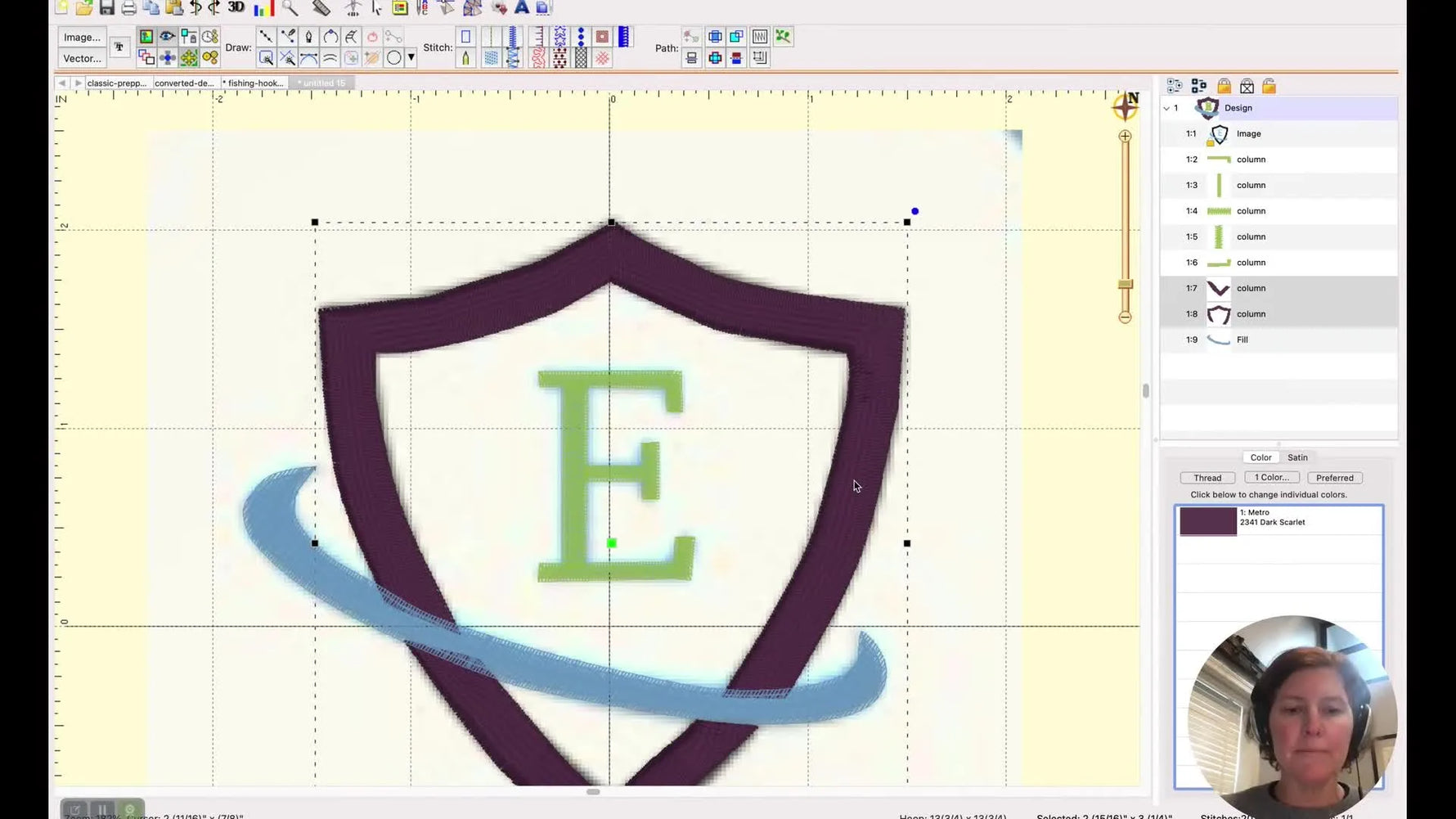 A full-screen preview of the finished digitized shield logo inside Embrilliance StitchArtist, showing clean colors and optimized stitch objects.