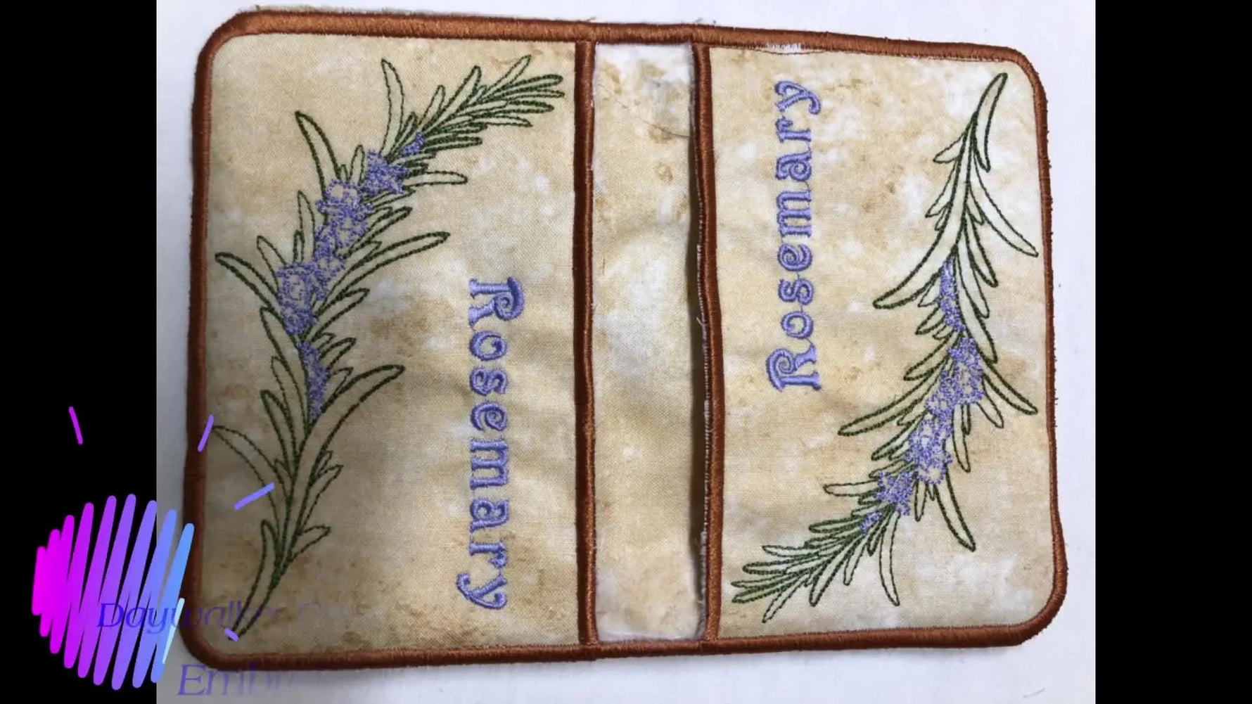 A close-up of the finished rosemary-themed in-the-hoop pot holder showing clean borders and the pocket-style construction.