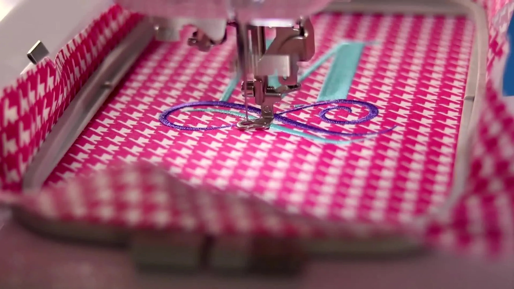 An overhead view of the finished satin-stitch “M” monogram completed in the Brother 5x7 hoop on a cutting mat.