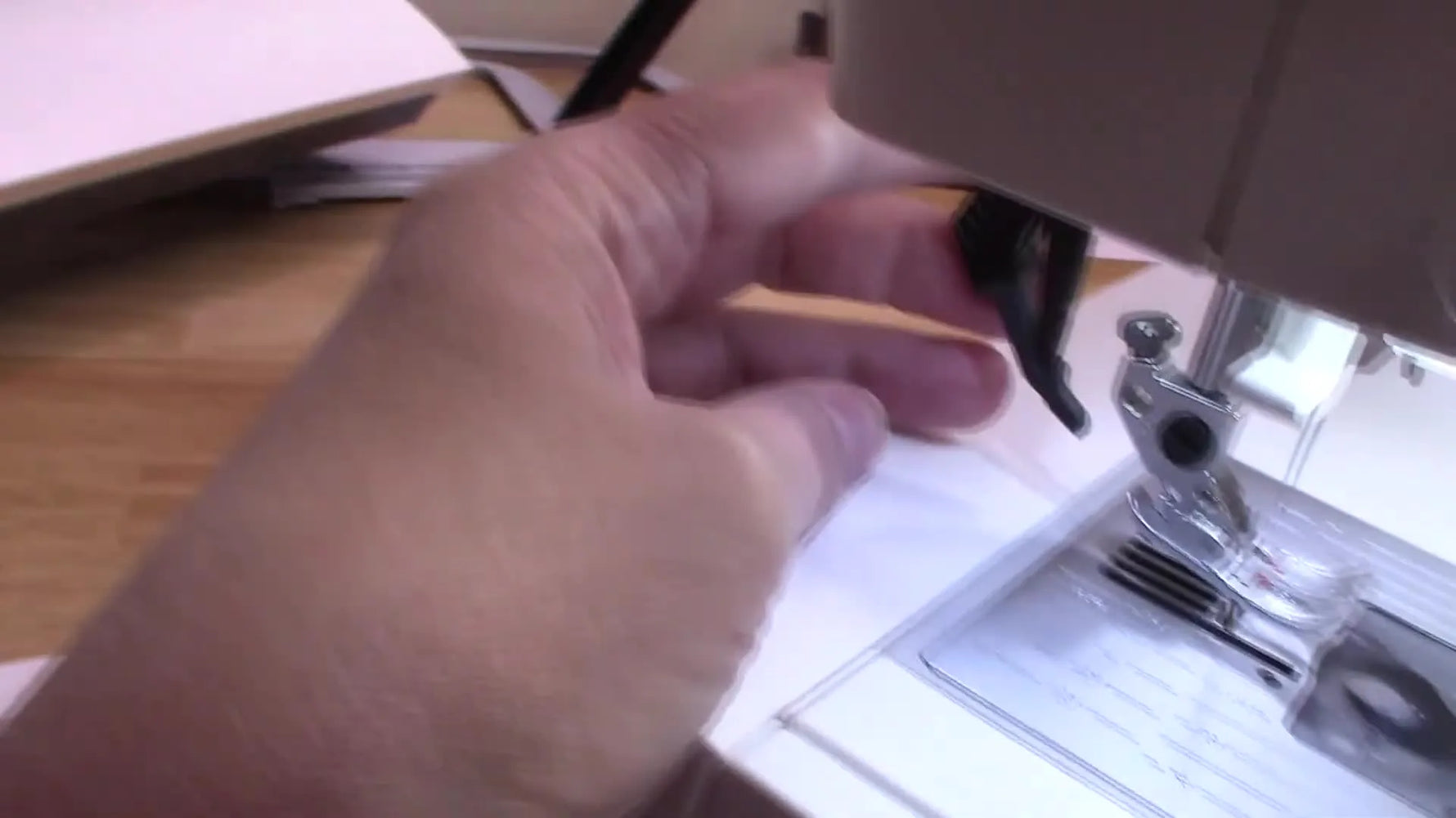 Close-up of the Pfaff Creative 4.0 IDT lever engaging into the back of the presser foot, showing the dual-feed mechanism in action.