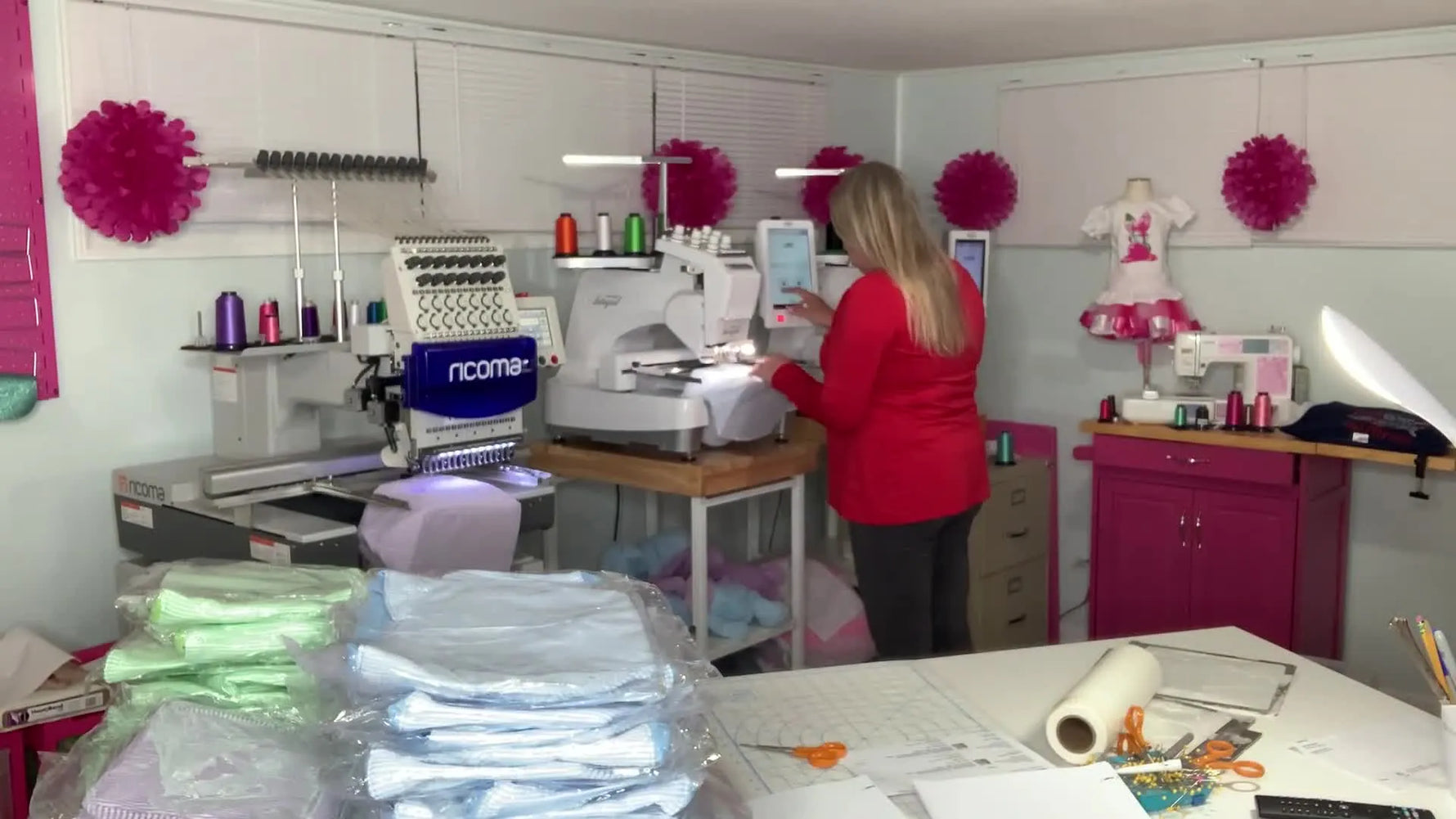 A close-up of a Ricoma multi-needle embroidery machine actively stitching a personalized design onto a seersucker tote during a high-volume production run.