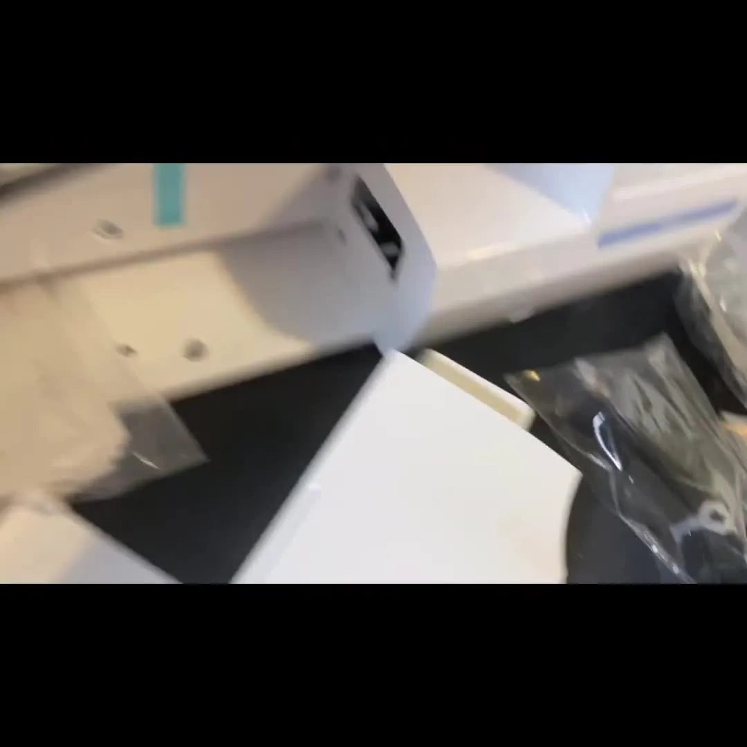 A newly unboxed Brother PE800 sits on a desk with blue transport tape still attached, ready for the first safe setup steps.