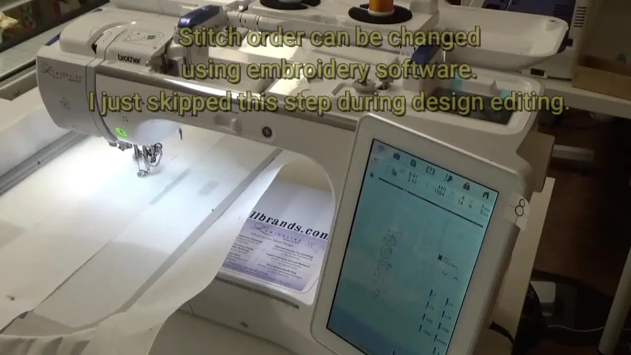 A close-up of the Brother Luminaire XP1 stitching crisp placement outlines for large appliqué letters inside the hoop.