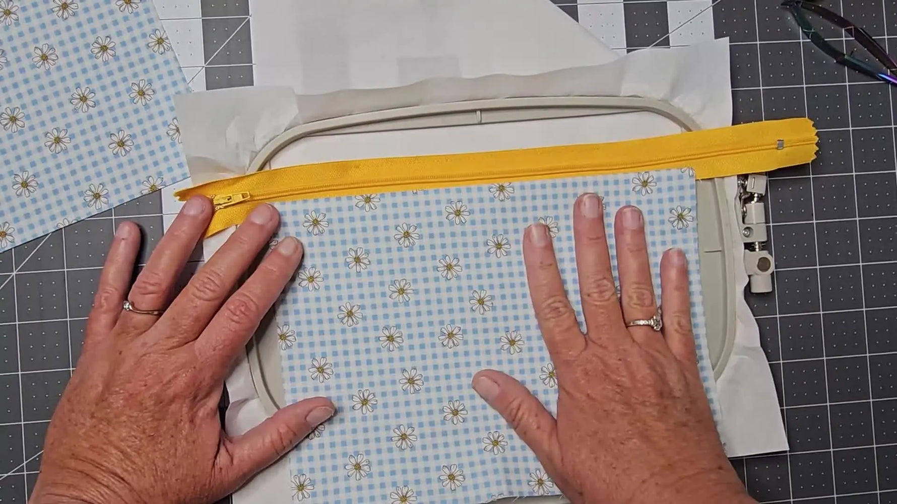 A close-up of the finished top stitch running neatly alongside the zipper teeth on the cotton Luna bag panel.