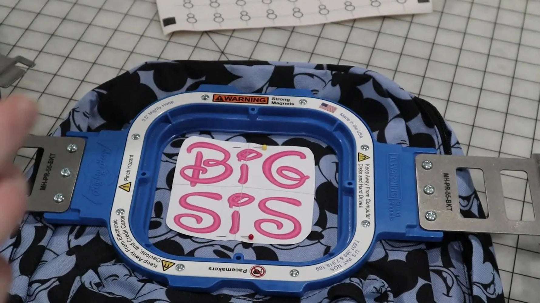 A close-up shows the Snowman positioning sticker crosshairs being aligned precisely over the printed template crosshairs for accurate camera-based design centering.