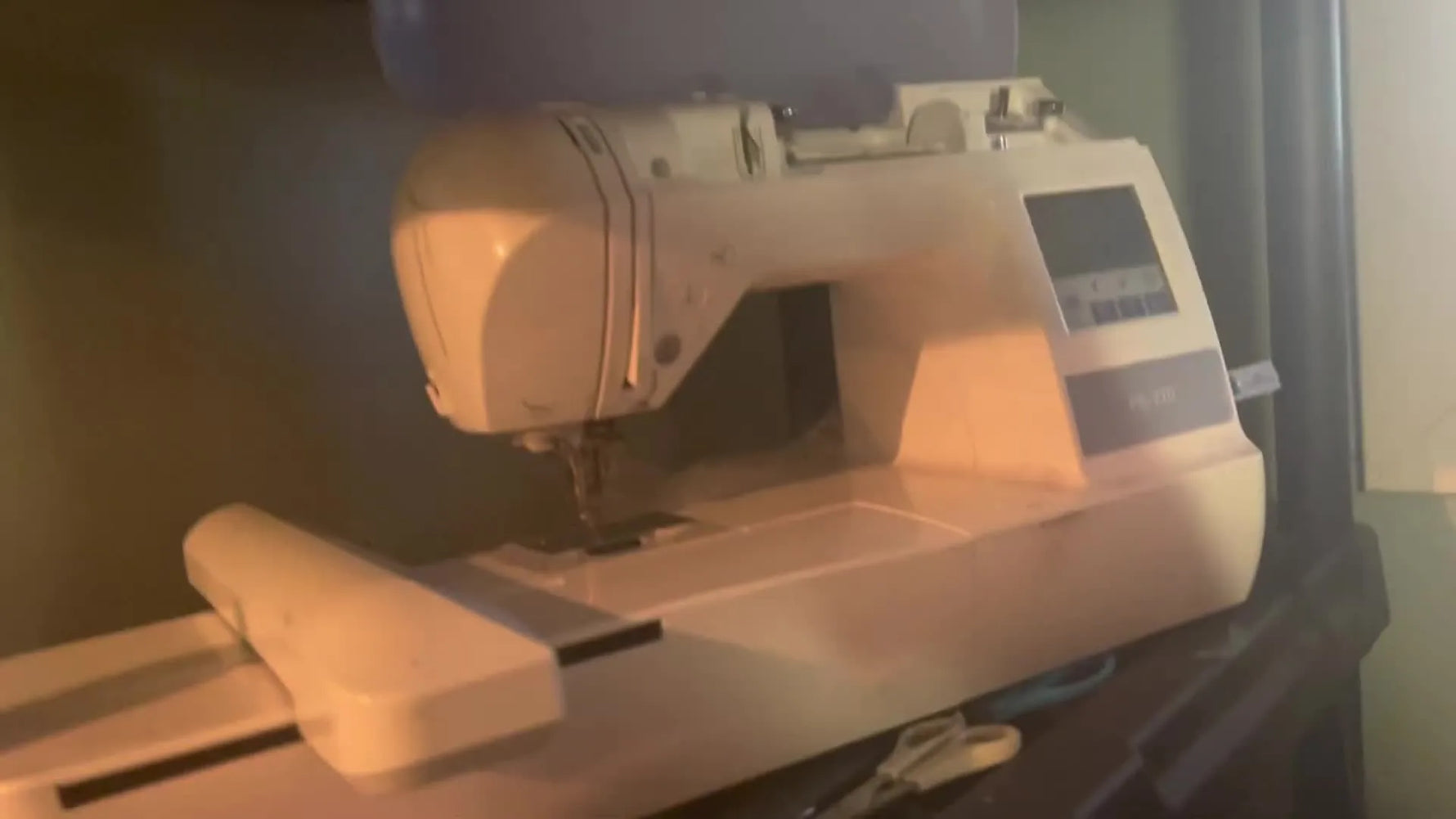 An angled close-up of the Romaker A15‑Plus 15-needle head with thread cones and the tension assembly visible, ready for its first test run.