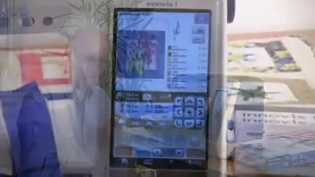 The Brother Innov-is I screen shows a scanned fabric background with a digital embroidery design overlaid for precise placement.