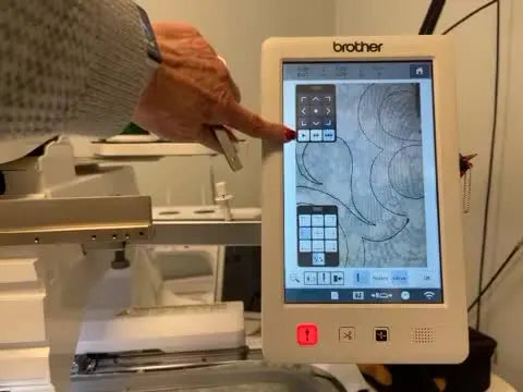 A close-up of the Brother PR1050X screen where the digital quilting design overlay is precisely aligned to the real fabric view using Live Camera View.