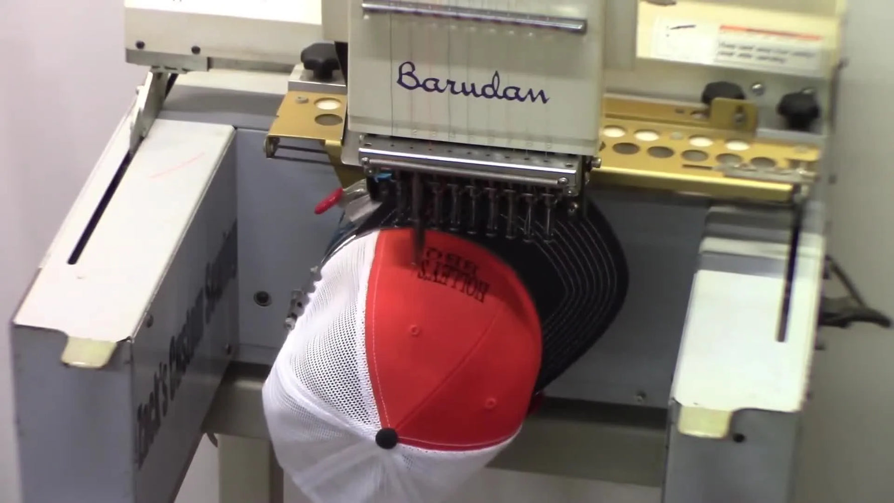 A crisp close-up of the finished Holley’s BBQ embroidery on a red Richardson cap, showing clean edges and solid coverage.