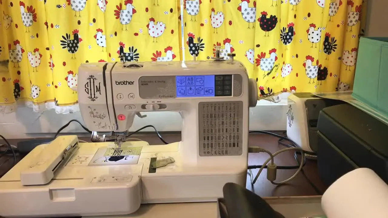 A wide shot of a Brother SE425 set up for embroidery on a desk, ready for a vinyl in-the-hoop project.