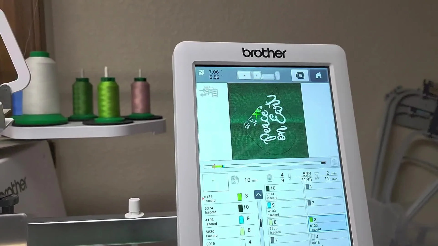 A Brother PR1055X multi-needle machine stitches white details onto green glitter fabric held in an 8x8 hoop.