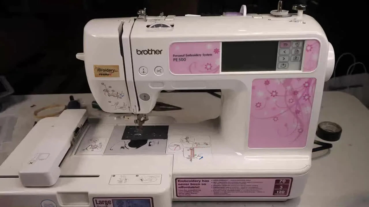 A Brother PE500 embroidery machine sits on a workbench ready for a full stitching test and troubleshooting.