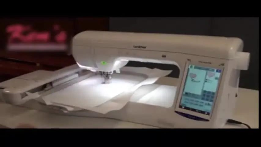 A close view of the presser foot lever being lowered as the Brother BP2100 Start/Stop button changes from red (locked) to green (ready).