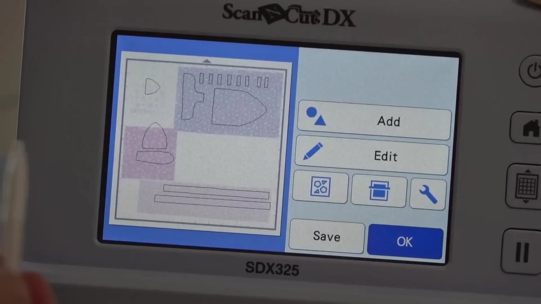 On the ScanNCut SDX325 screen, digital cut lines are dragged into position over a scanned photo of fabric scraps for precise appliqué cutting.