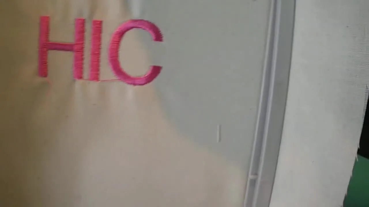 Final embroidered 'HIC' text in pink thread on light fabric.