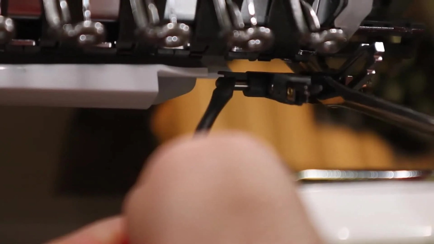 A close-up shows the two-screwdriver technique used to unclip the Brother PR Series needle threader assembly from its shaft.