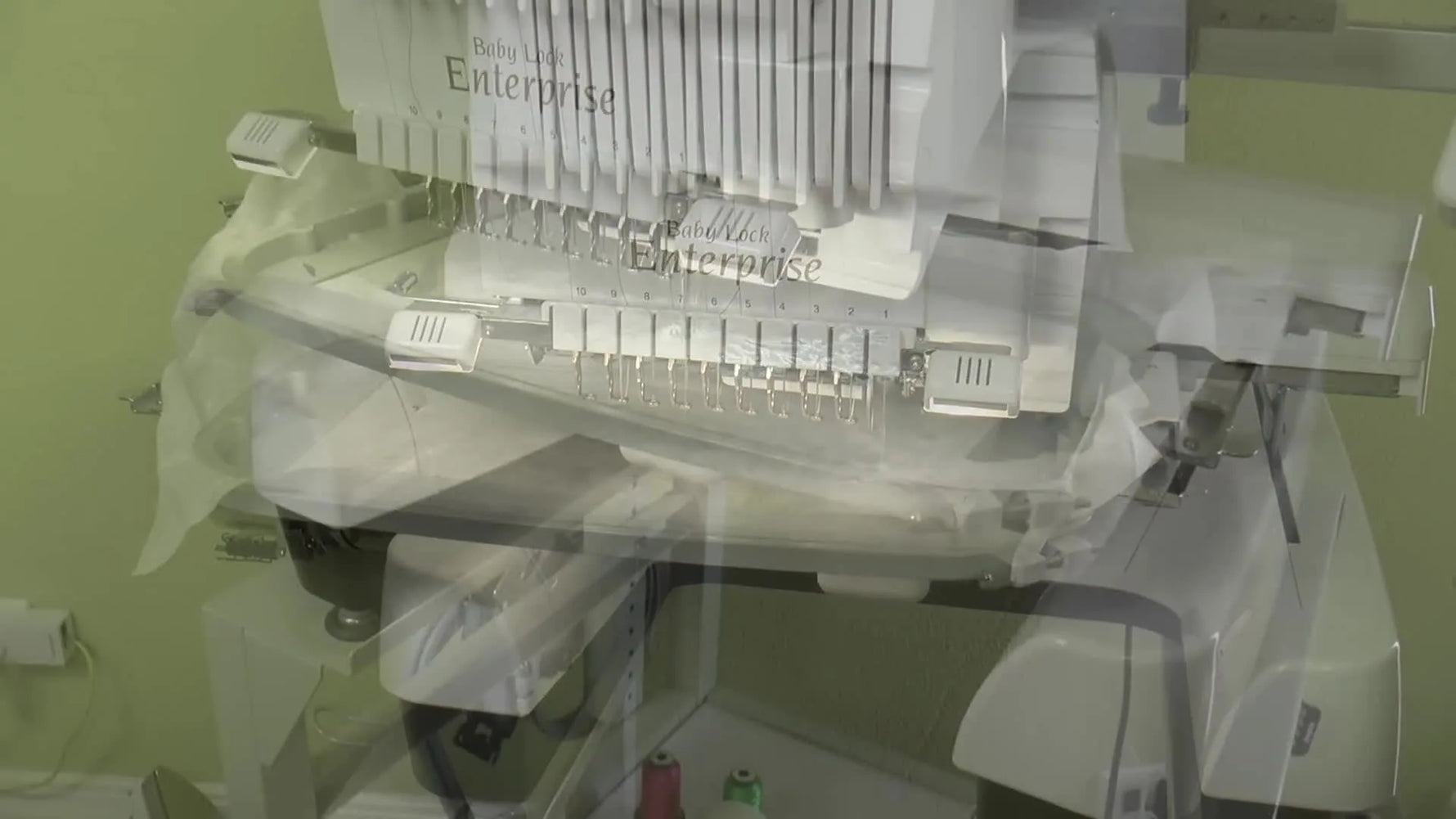 An overhead view of a multi-needle embroidery machine stitching a freestanding lace motif on water-soluble stabilizer.