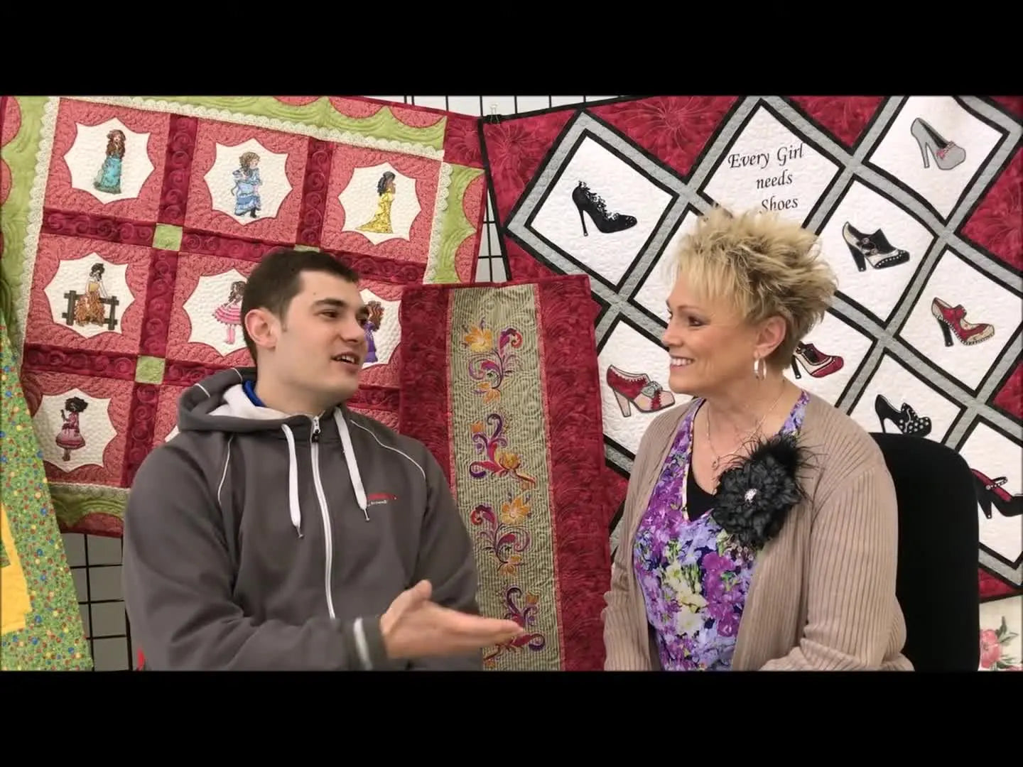 Chris Blakeman interviews Debbie from Floriani in front of embroidered quilts and sample pieces, setting the tone for education-first embroidery success.