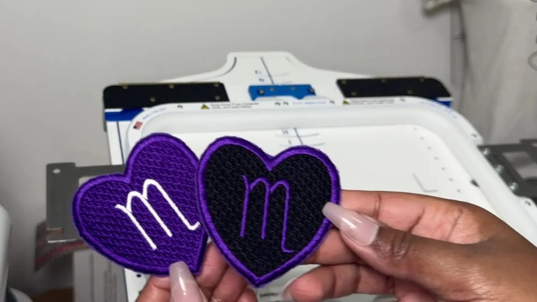 A close-up comparison of two finished heart-shaped felt patches showing how material and trimming choices change the final quality.