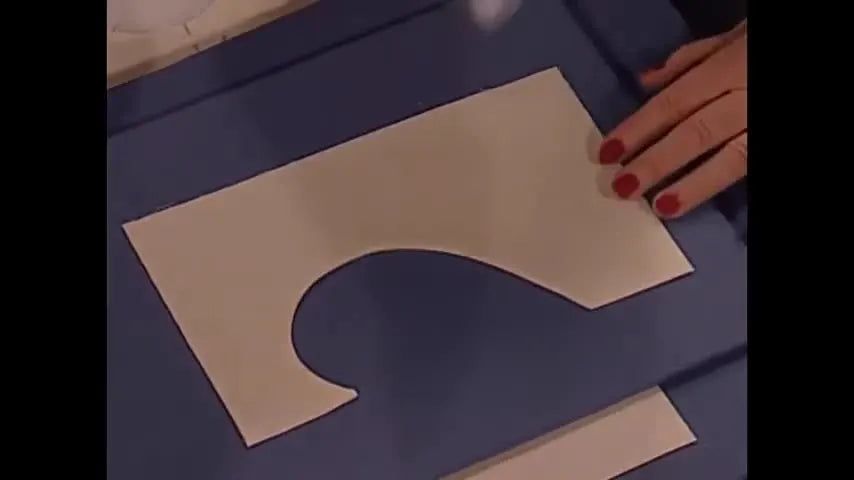 Hands pull two fabric layers apart to reveal a perfectly formed Magic Madeira heart appliqué in the “magic moment.”
