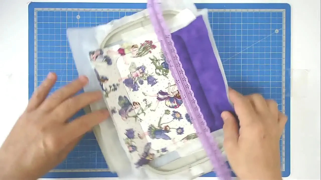 Hands open the zipper to the center of the hoop—shown as the critical moment that makes turning the ITH bag possible.