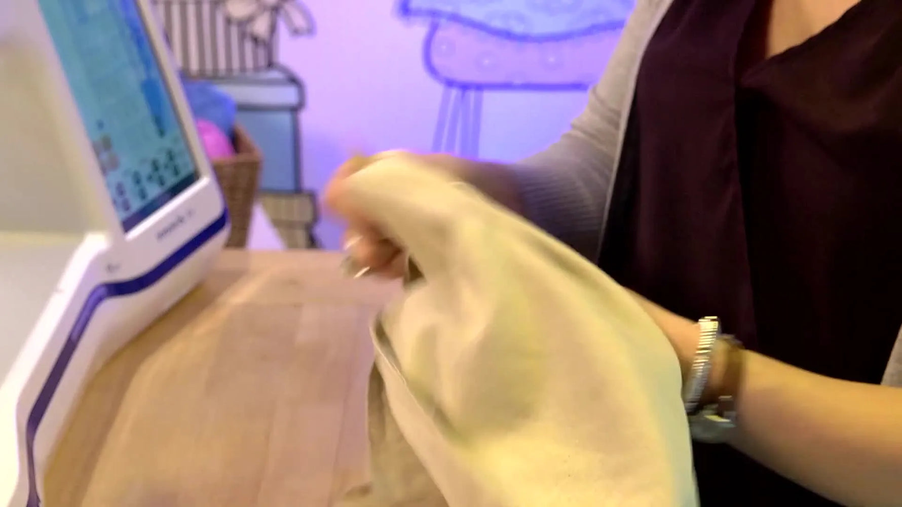 A finished, stuffed cushion is held up to show a child’s scanned dog drawing stitched in black on beige linen with an envelope-back closure.