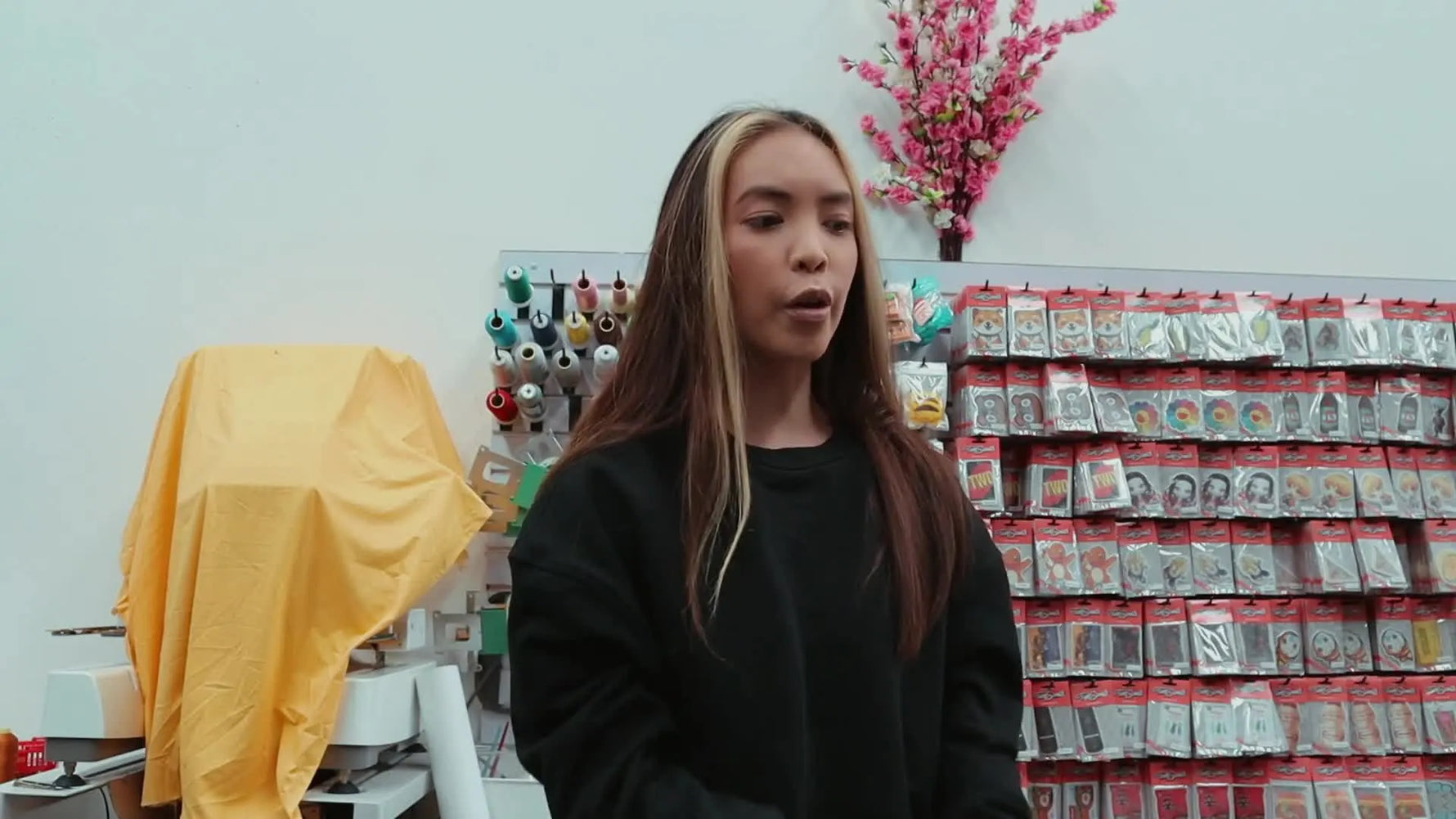 Woman holding a cardboard box labelled 'THE MODERN UNIFORM', with the top flap reading 'GOOD NEWS! YOUR CARGO IS HERE!'