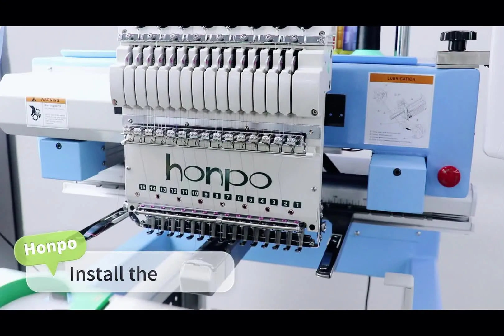 A hooped sock frame is being slid onto the Honpo machine’s pantograph arms, showing the critical mounting step before stitching.