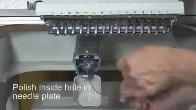 Close-up of hands using Crocus Cord in a flossing motion through the needle plate hole to polish away a thread-cutting burr.