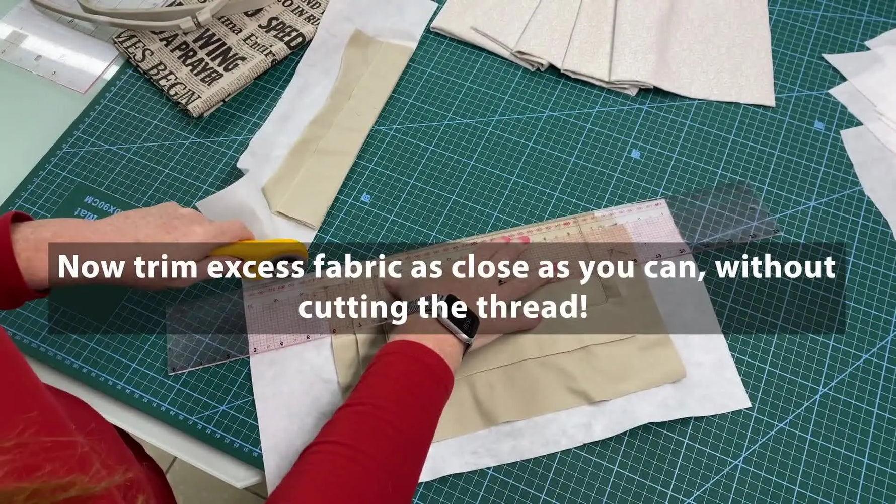 Hands moving the zipper pull to the center of the wallet while it is still hooped.