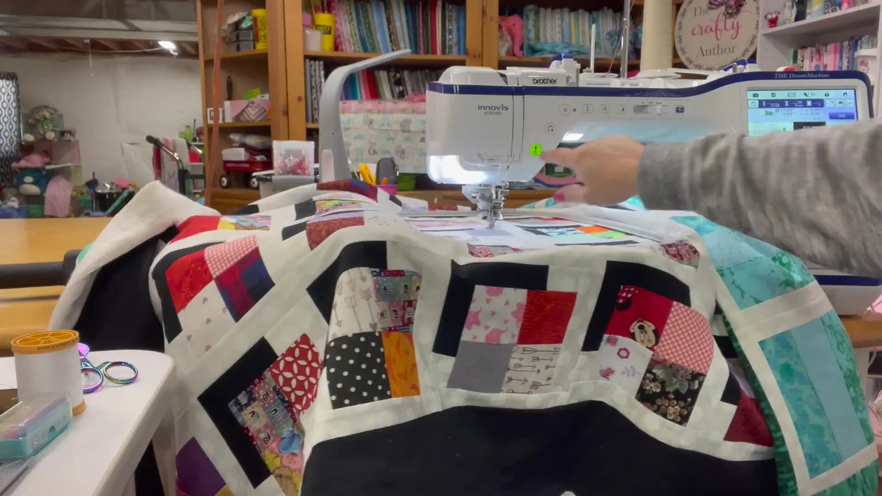 A Brother embroidery machine stitches an end-to-end quilting pattern across a thick quilt sandwich in the hoop.