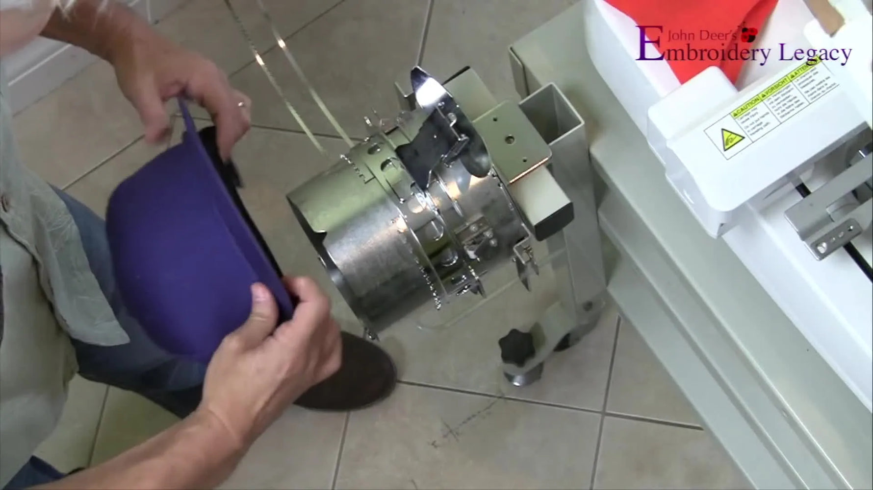 A close-up shows a finished cap being slid onto a cylindrical cap frame on a jig, with careful alignment before clamping.