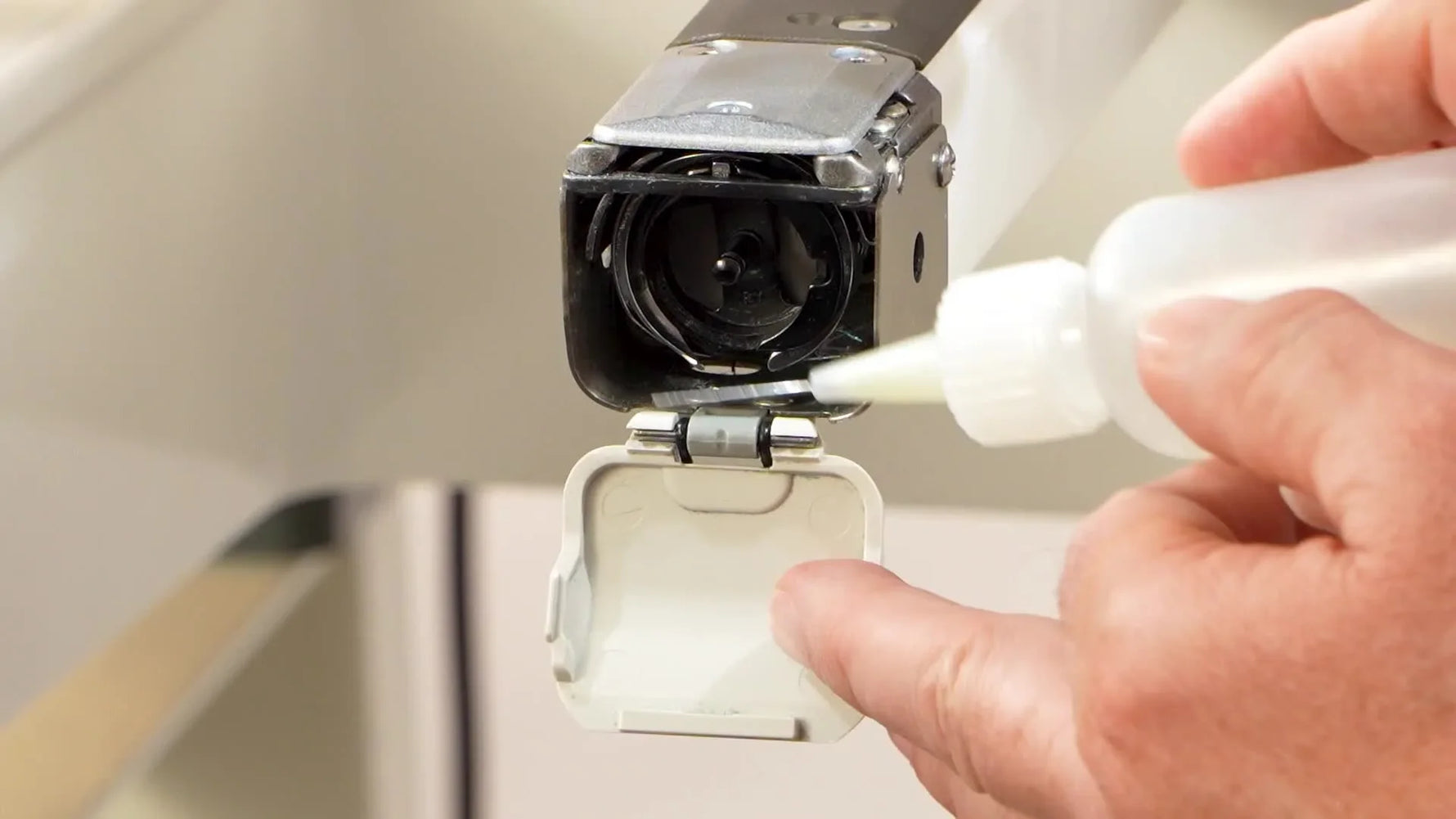 A close-up shows a fine-tip bottle placing oil precisely into the Halo X rotary hook race.