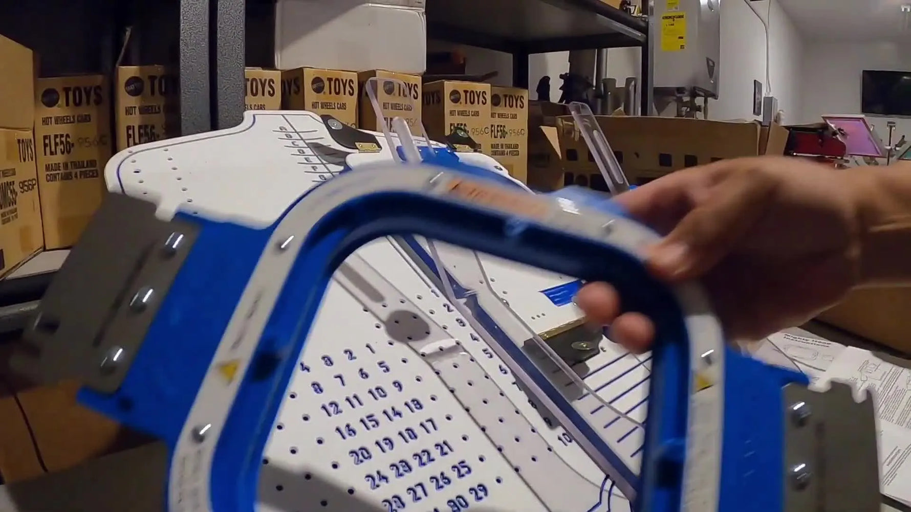 A close-up of the 5.5-inch magnetic hoop with its blue ring and warning label, highlighting the tool you’ll handle most during production.