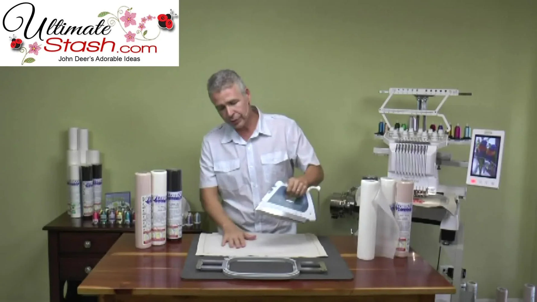 An iron presses a fusible no-show mesh stabilizer onto fabric to create a bonded, slip-free embroidery sandwich.