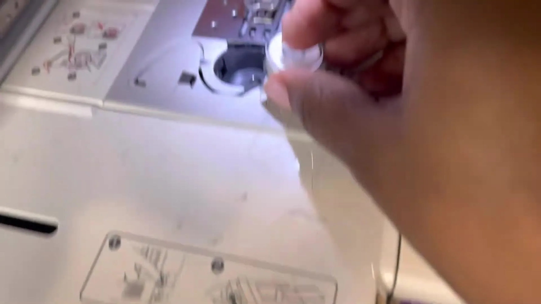 An overhead close-up shows a pre-wound bobbin being dropped into the Brother SE400’s horizontal rotary hook assembly.