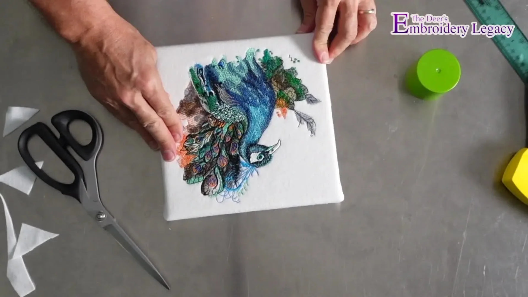 A finished peacock machine-embroidery design mounted tightly on a pre-made canvas frame with crisp, gallery-wrapped edges.