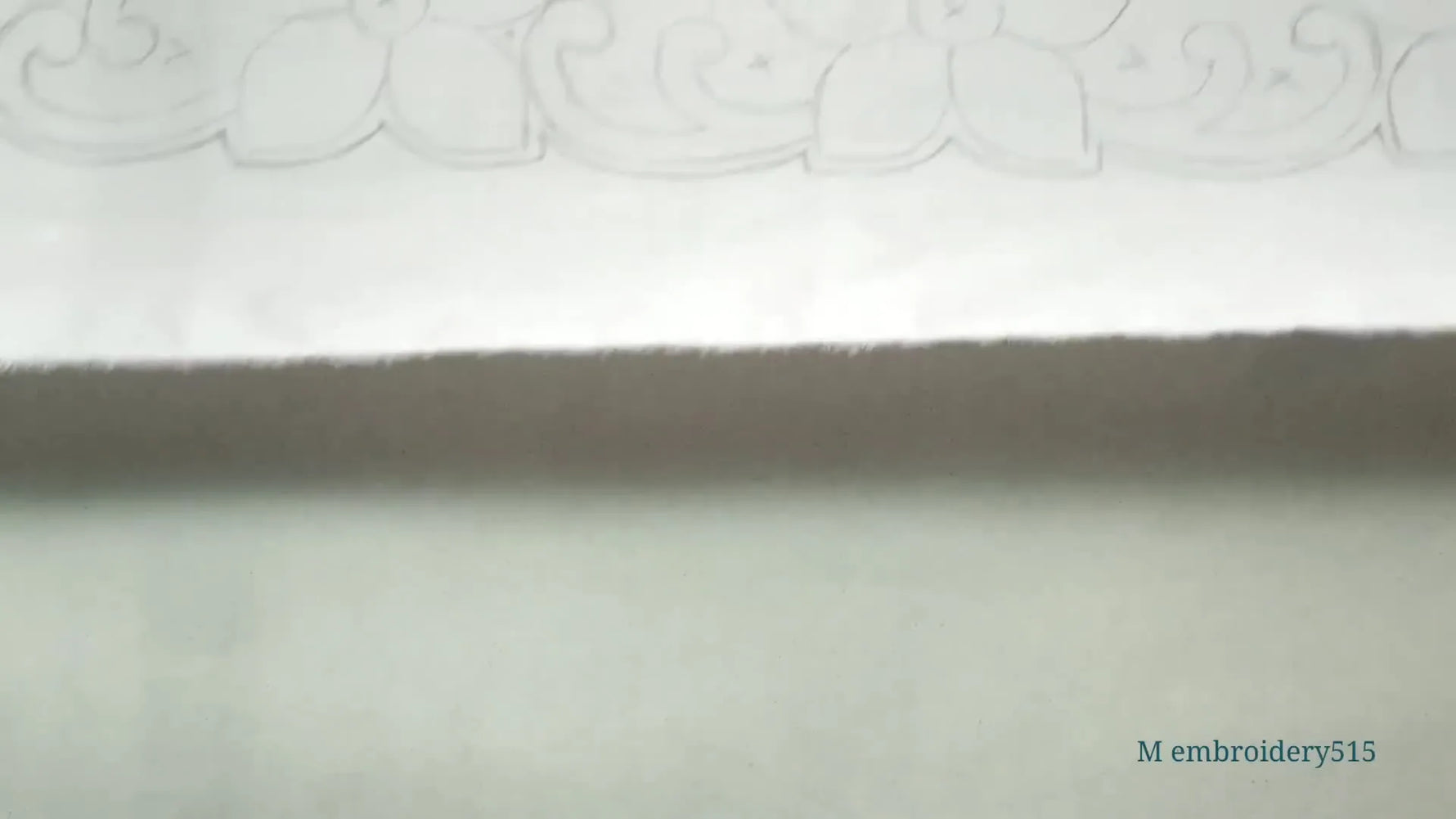 Finished cutwork embroidery on white fabric with gold accents.